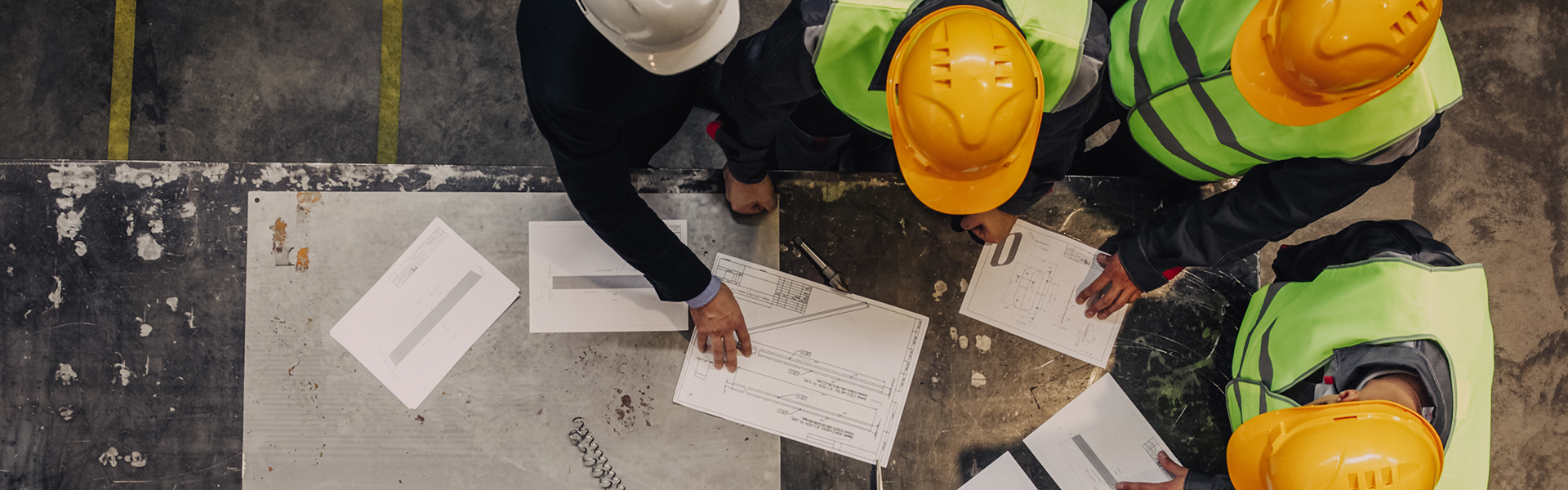 Workers discussing drawings