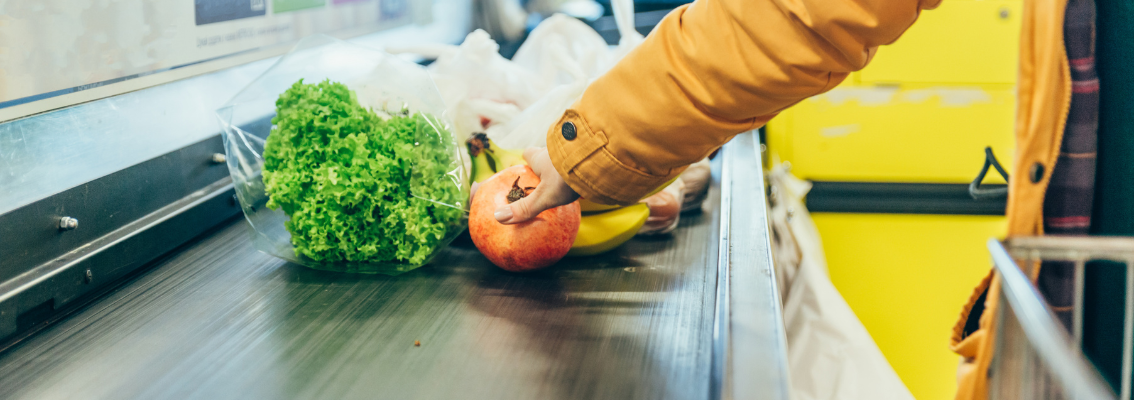 Woman put products on cash line in