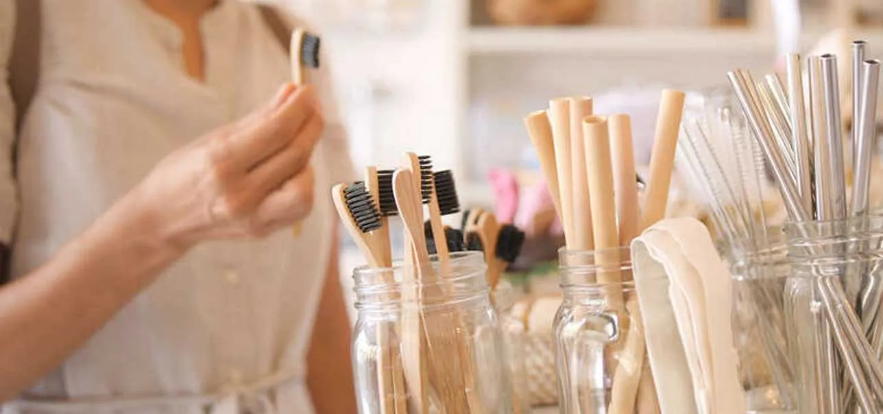 Woman choosing bamboo eco friendly biodegradable toothbrush